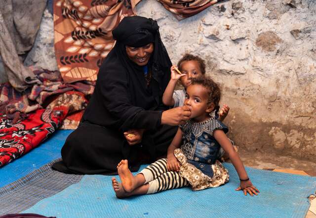Asriya feeding her twins, then aged two.