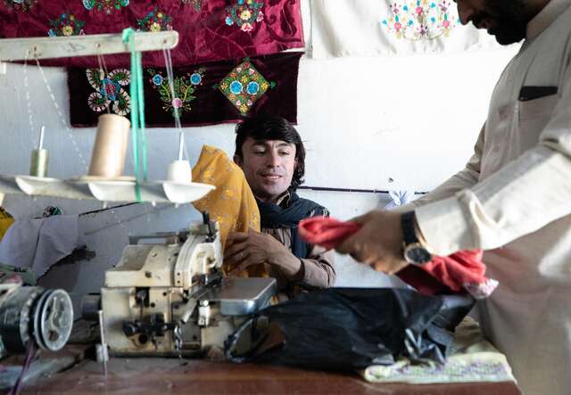 Darweza working at his sewing station.