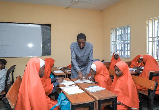 A teacher addresses a group of students in Borno State, Nigeria