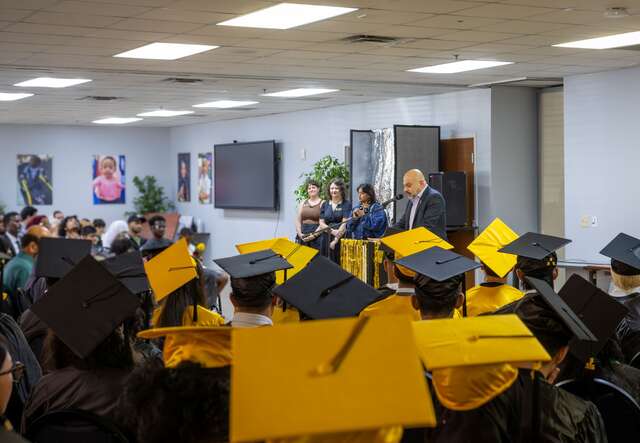 Image of IRC team members speaking to graduating Kickstart students.