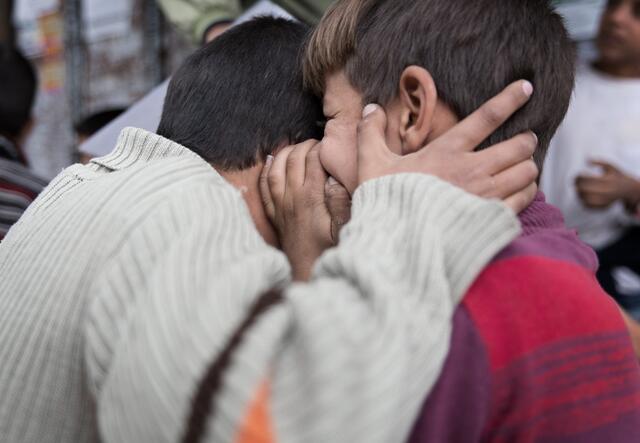 Two boys take part in Chinese Whispers during an activity as part of IRC's work to get children off the streets and back into school in Lebanon.