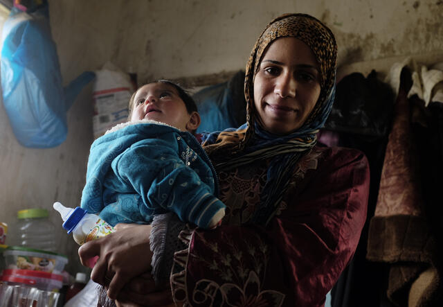 A Syrian woman with her child living in Jordan