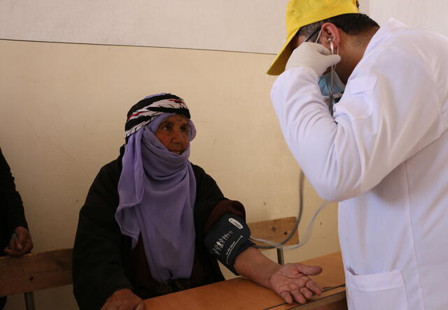 An IRC nurse checks a patient’s blood pressure during a mobile clinic day in northeast Syria.
