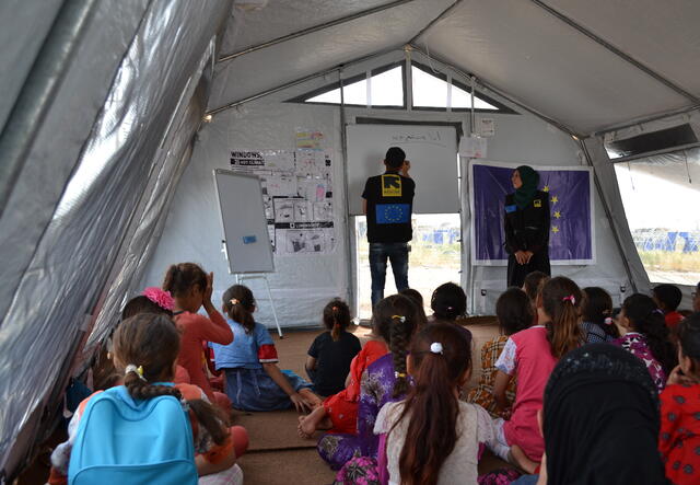 Two IRC aid workers lead a class in the tent that serves as a safe healing and learning space in Nargazilia camp.