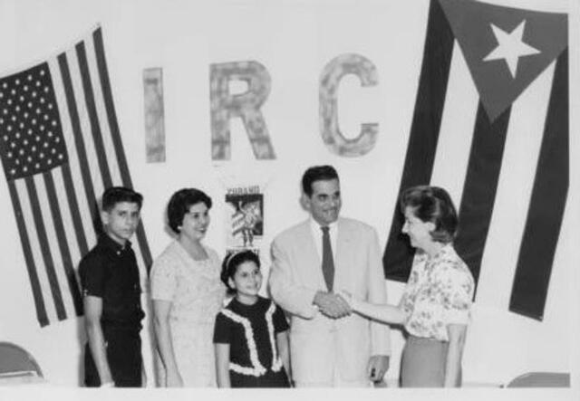 A group of people posing in front of the IRC birthday party sign.