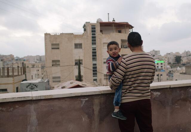 Hudaifah on his balcony with son Bilal 