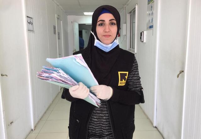 Doha Ibrahim Ammouri stands in a corridor in the IRC's clinic in Azraq refugee camp in Jordan.
