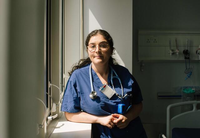 Dr. Anxhela Gradeci stands by a window in the Whittington Hospital in North London.