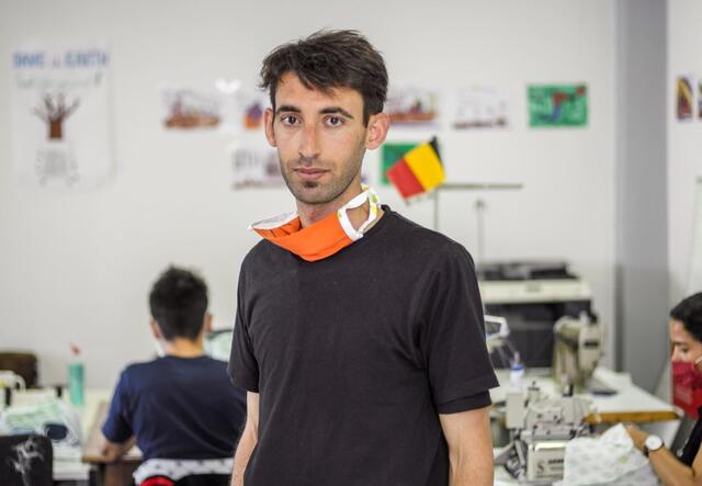 Ammar Marash stands in a centre in Athens, Greece where he makes masks to help people say protected from the pandemic.