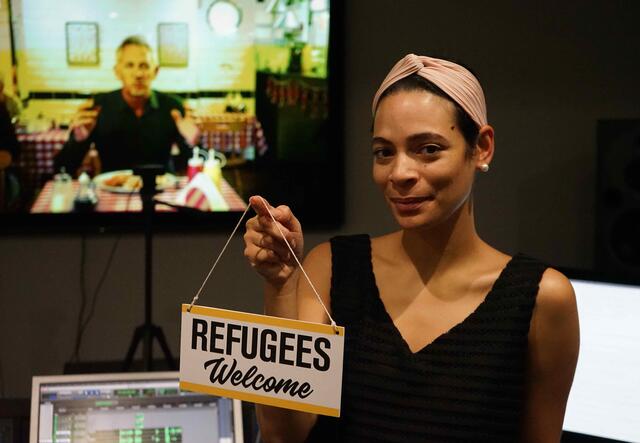 Yasmin Kadi holding refugees welcome sign