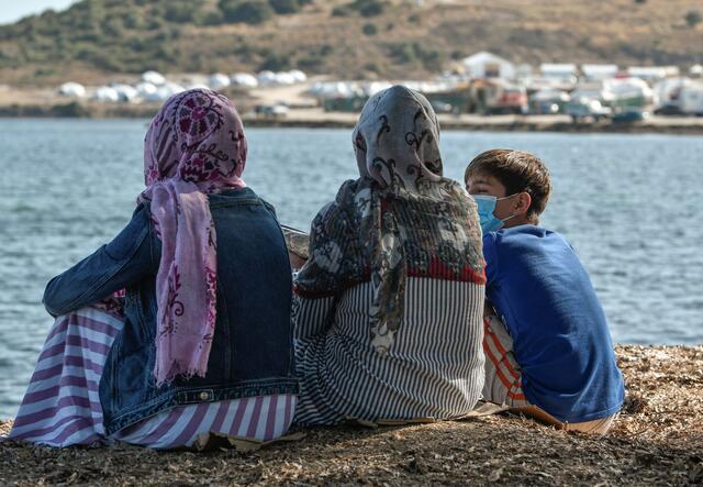 Rahima sitting with two members of her family.