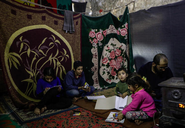 A family displaced from Idlib province in the unfinished building they are renting in the town of Ma’aret Misrin. Fighting in 2019 and early 2020 forced nearly one million people to flee their homes, many multiple times.