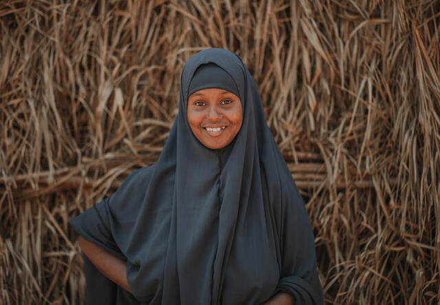 Nurta smiles at the camera.