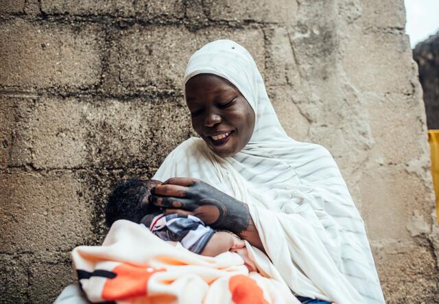 A woman, 20-year-old Hussaini, holding her newborn baby