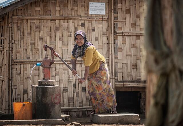 Ma Than Than Win pumps water from the well in Phwe Yar Kone camp, Myanmar.