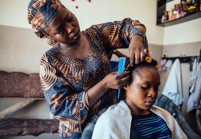 Hairdresser Abigail styles a customers hair.