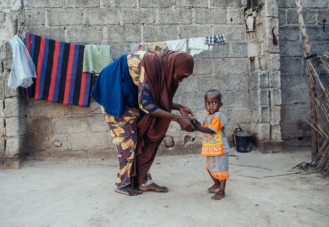 Mum Hajji helps her Baby Mustapha to walk again after recovery from severe acute malnutrition.