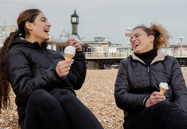 Chadia and her daughter Nour eating ice cream on Brighton beach