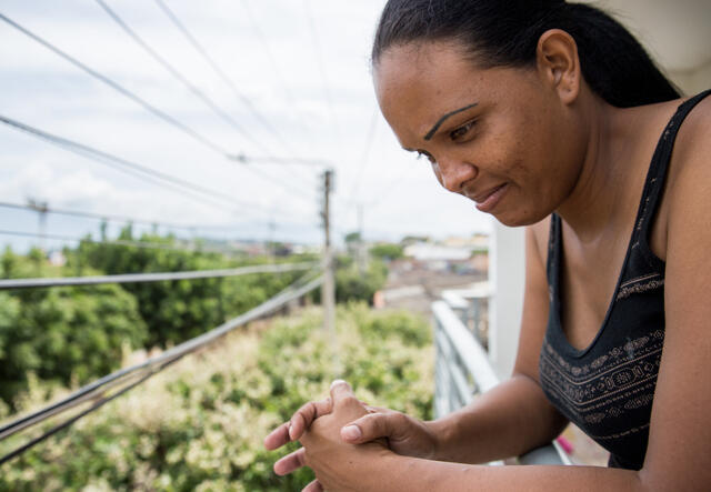 Cibel Ortiz looks out over a balcony in Cúcuta, Colombia.