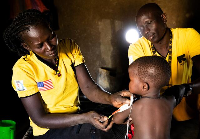 Health workers in South Sudan measure a toddler's arm for signs of malnutrition. 