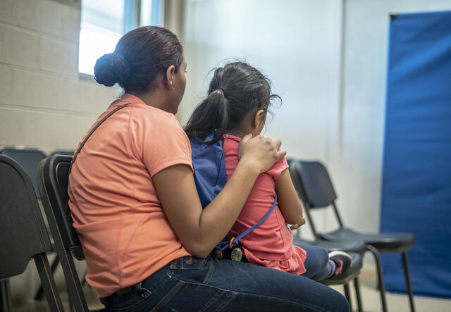 Emilia sits with her arms around four-year-old Lauda in a shelter in Phoenix, Arizona for asylum-seeking families who were released from detention at the U.S. border