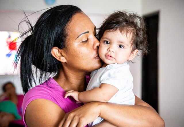 Cibel Ortiz kisses her baby daughter Diana, named after an IRC nurse