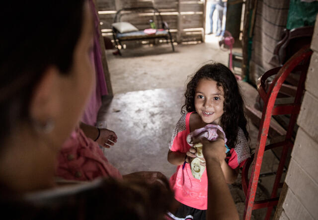 Venezuelan refugee Andrea and her young daughter in their homebuilt of scrap wood in Cucuta, Colombia