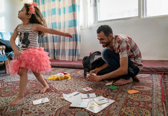 Anas, an IRC Reach Up & Learn volunteer and Syrian refugee, plays with his daughter Maria, 4 years old, at their home in Mafraq Jordan.