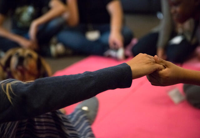 Refugee community supporting each other and holding hands