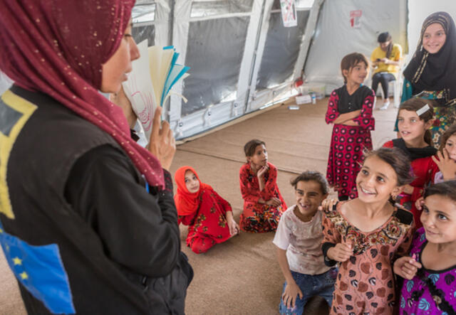 Woman teaching children