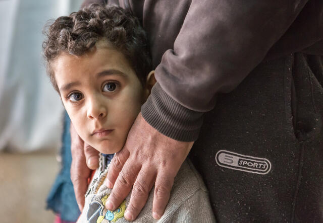 Parent holding son's shoulders