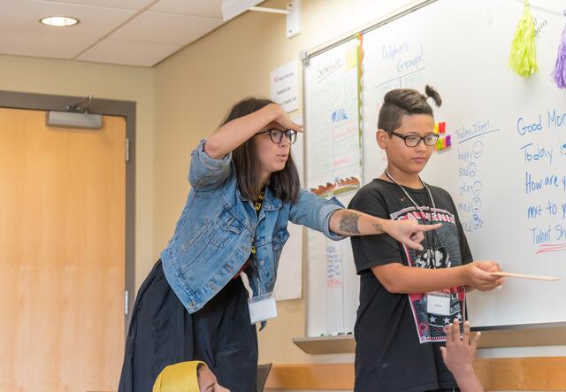 teacher supporting student in a classroom