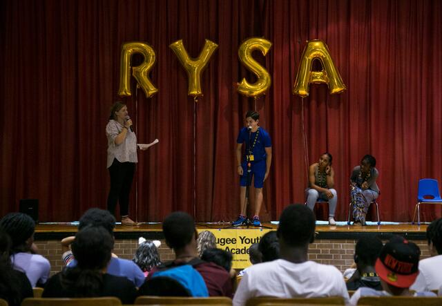 3 youth participating in RYSA game in the auditorium
