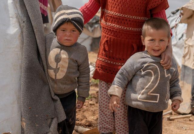 A group of children outside their tent in Areesha camp, Northeast Syria, where the IRC is supporting displaced families.