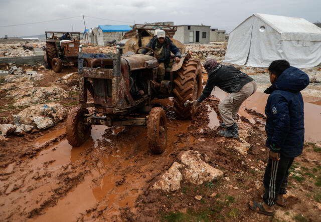 Tractor in informal settlement in Deir Hassan in northwest Idlib gets stuck in the mud