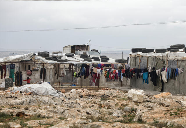 Clothes hang in settlement for displaced Syrians on outskirts of Deir Hassan in Idlib 