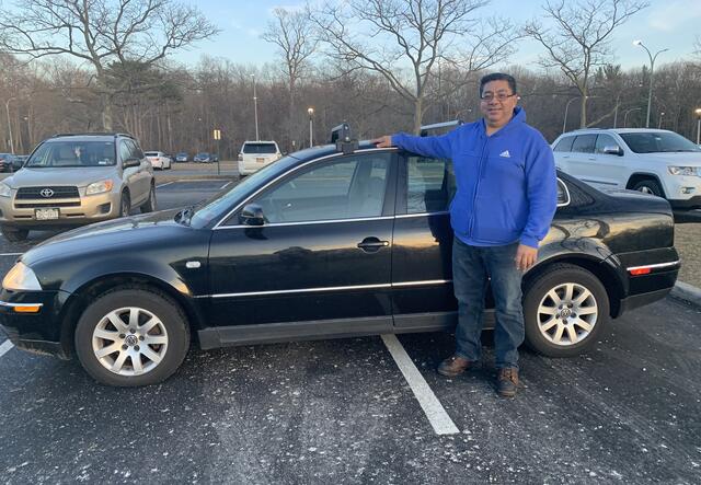 Liber client standing outside with his new car