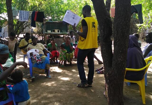 A Community Health Worker speaks to the community in Kakuma refugee camp in Kenya. 