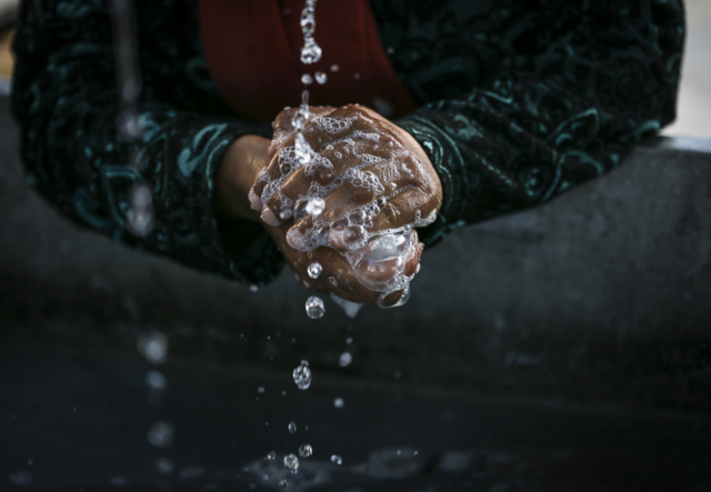 Photo of handwashing, close up of hands for COVID-19 pandemic.