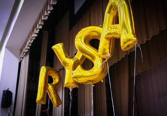 Yellow Ballons spelling out RYSA, raised high in the auditorium