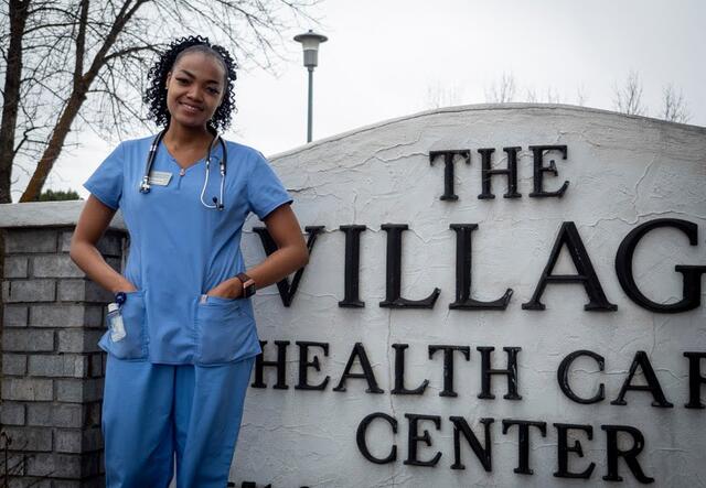 Rita Jemimah Bush stands outside her workplace 