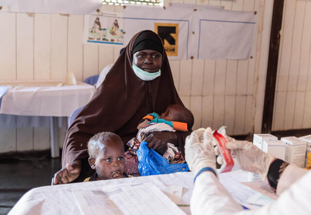 Amina with her children at an IRC health center where the staff treats children for malnutrition