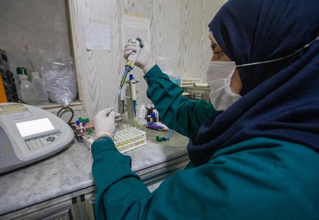 A lab technician analyzing a blood test at Idlib Surgical Hospital, a hospital supported by the IRC in northwest Syria. PHOTO: Khaled Idlbe/IRC