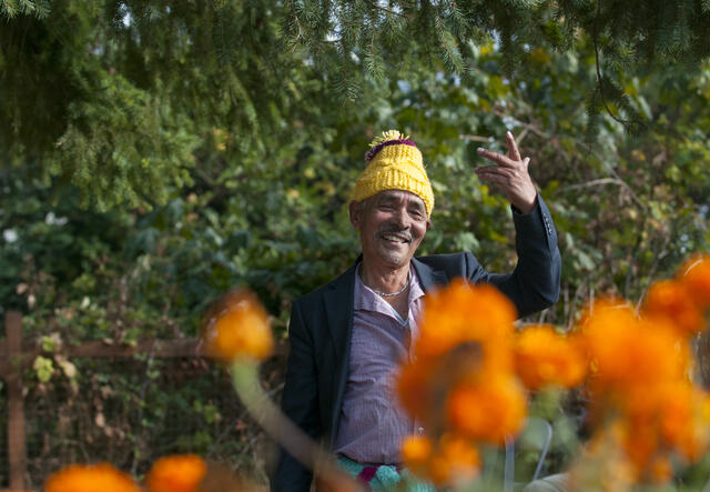 Elder Nepali man dances at IRC community garden.