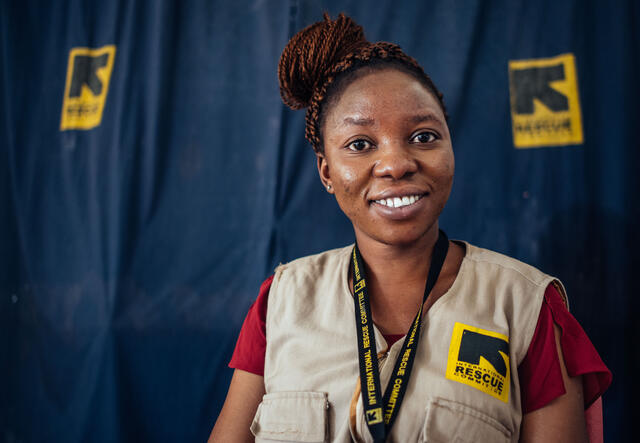 Wearing an vest with an IRC logo, Murna looks at the camera and smiles. 