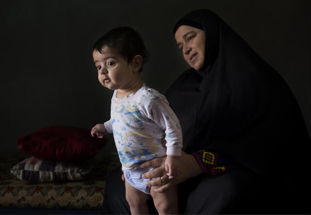 Syrian woman with her toddler grandson in Jordan