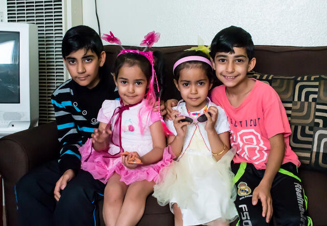 Syrian refugee children in their San Diego apartment