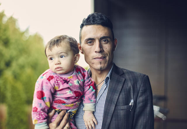 Adil with his son Steven outside their apartment