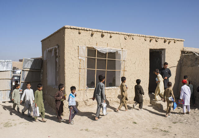Afghan boys line up and enter their primary school