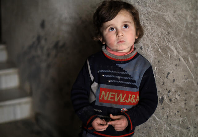 Syrian boy in underground bunker by the stairs